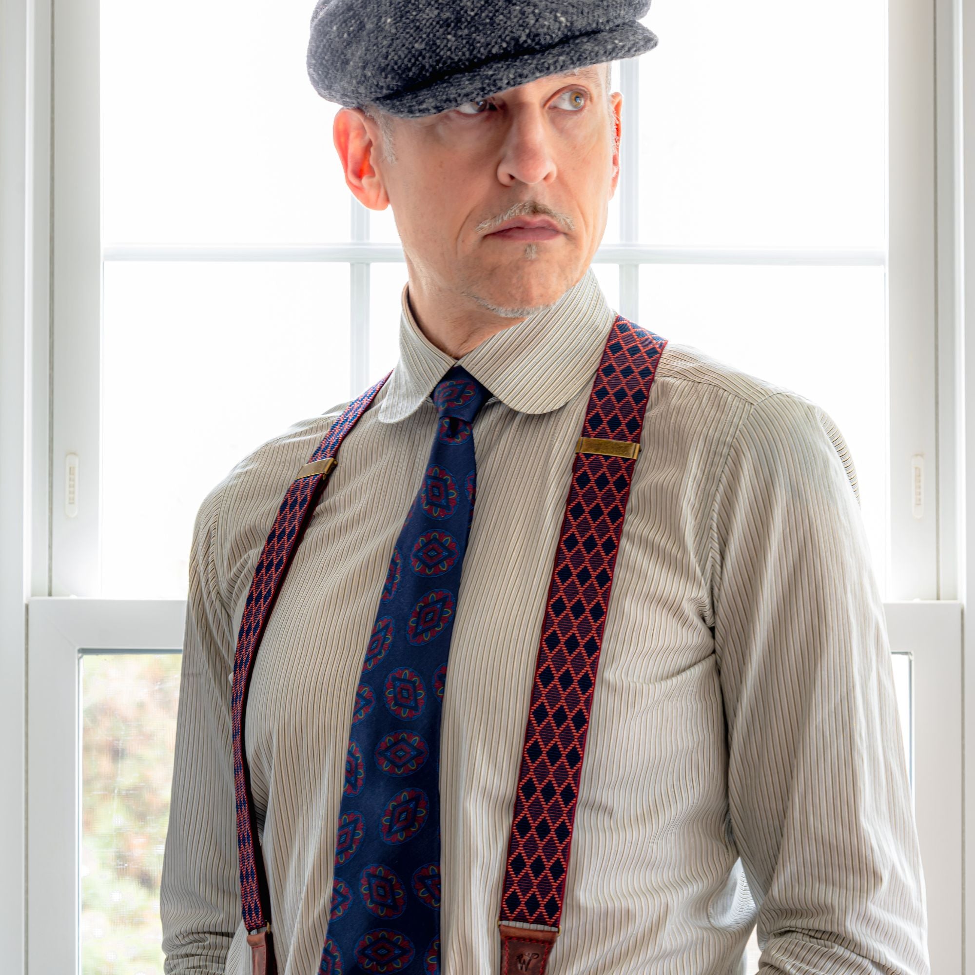 Man wearing Wiseguy Original Suspender with red, gray, black diamond pattern